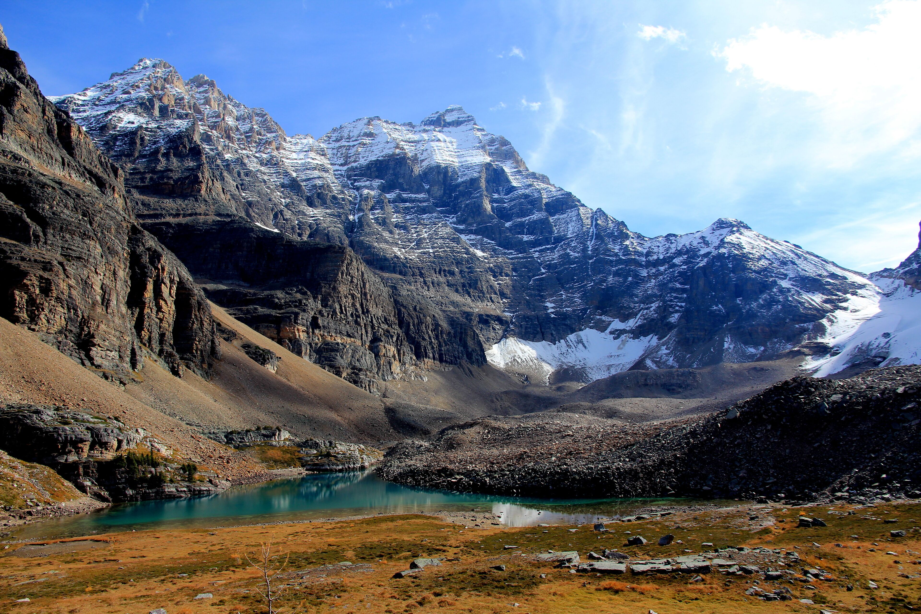A mountainous landscape with a clear blue sky and a lake.