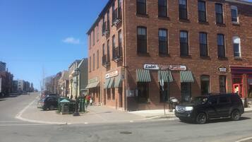 A brick building with a coffee shop and restaurant on the ground floor.