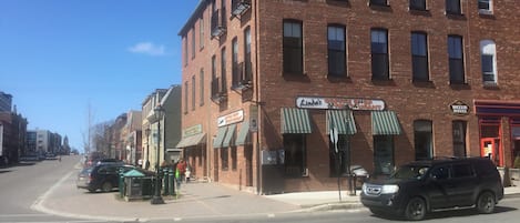A brick building with a coffee shop and restaurant on the ground floor.