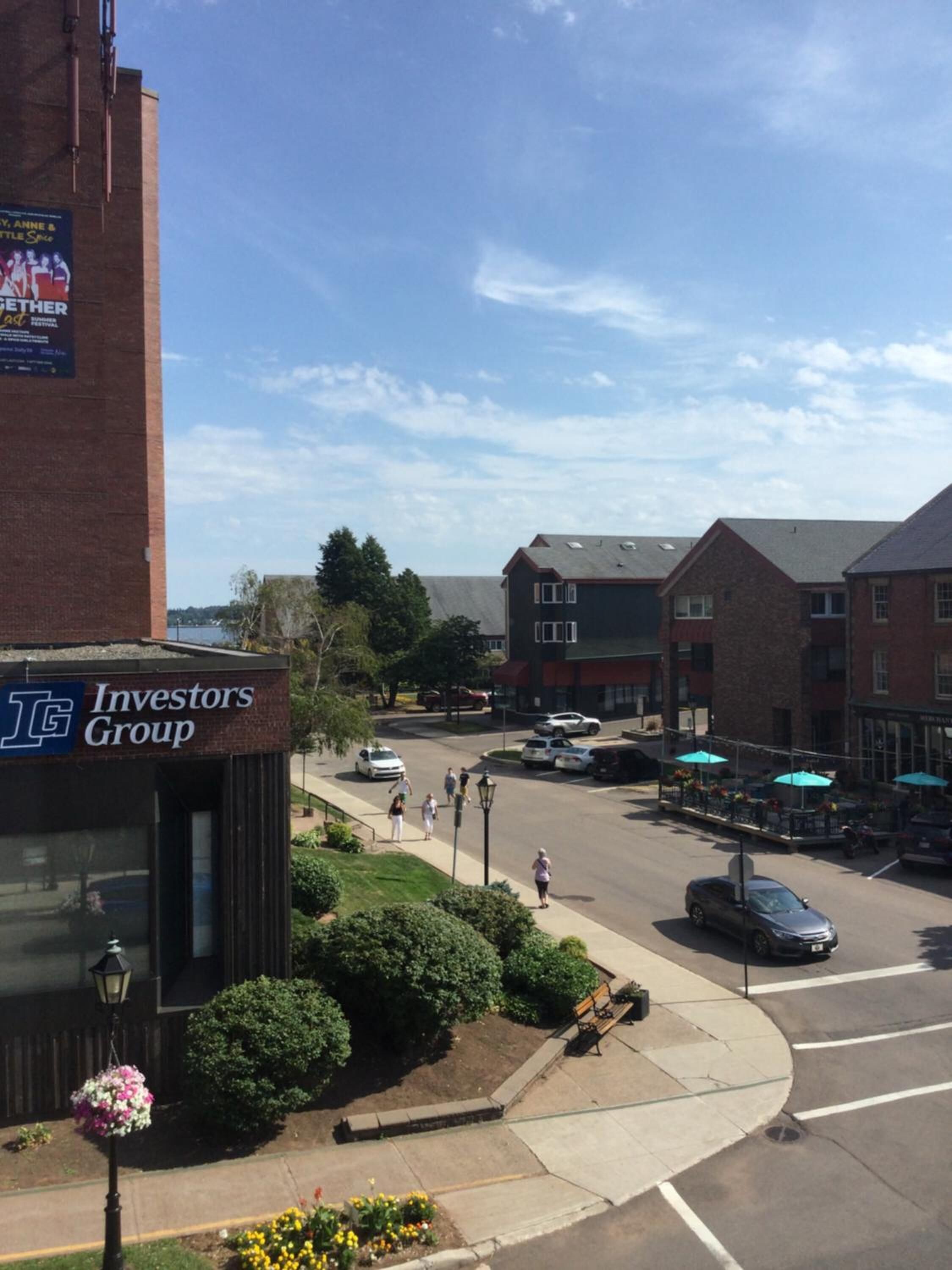 A street view with a building labeled "Investors Group" and a clear sky.