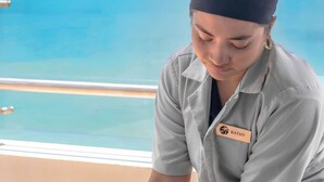 A person receiving a massage on a balcony with a view of the ocean. - Golden Bay Hotel by Marine Parade (Belize City)