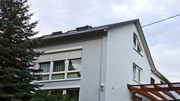 A two-story building with a white exterior, large windows, and a visible balcony. - Vacation apartment type 1, 50sqm, 1 bedroom - Ferienhaus Irene (Vogtsburg im Kaiserstuhl)