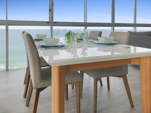 Enjoy a stylish dining experience with a panoramic ocean view from this spacious dining area.