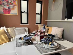 Enjoy a formal dining experience with a beautifully set table and elegant centerpiece.