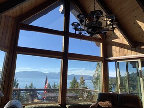 Enjoy a panoramic view of the lake and surrounding mountains from this room's large windows.