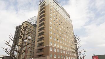 A multi-story hotel with a modern design, featuring a prominent sign at the top.