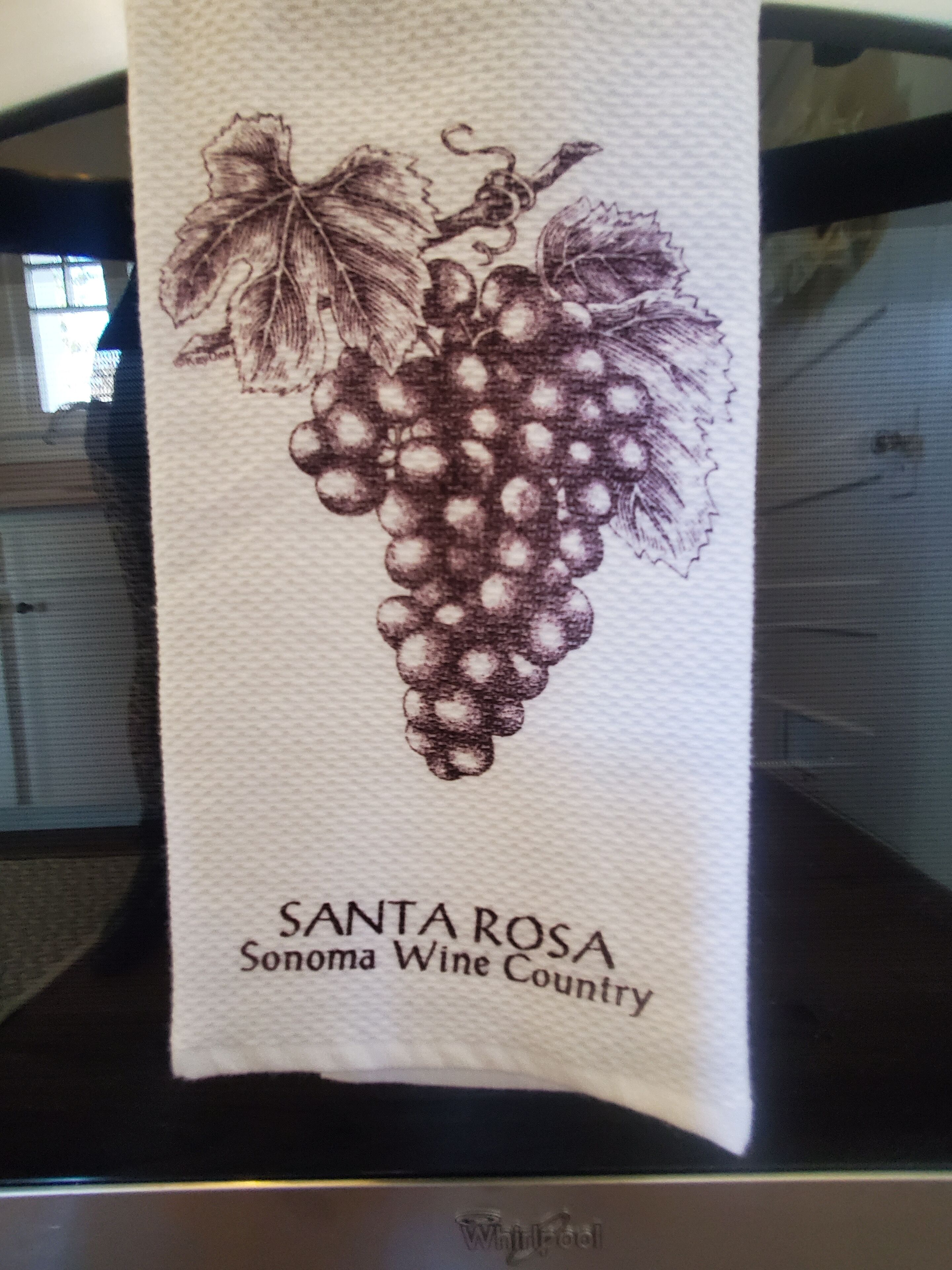 A towel with a grapevine illustration and the text 'SANTA ROSA Sonoma Wine Country'.