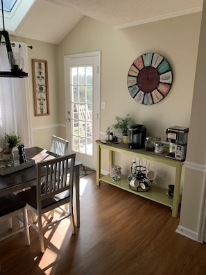 Enjoy a spacious living space with a dining area, kitchen, and skylight.