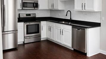 Microwave, dishwasher, coffee/tea maker, cookware/dishes/utensils