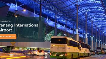 An airport terminal with a modern design, featuring a large glass facade and a distinctive roof structure.