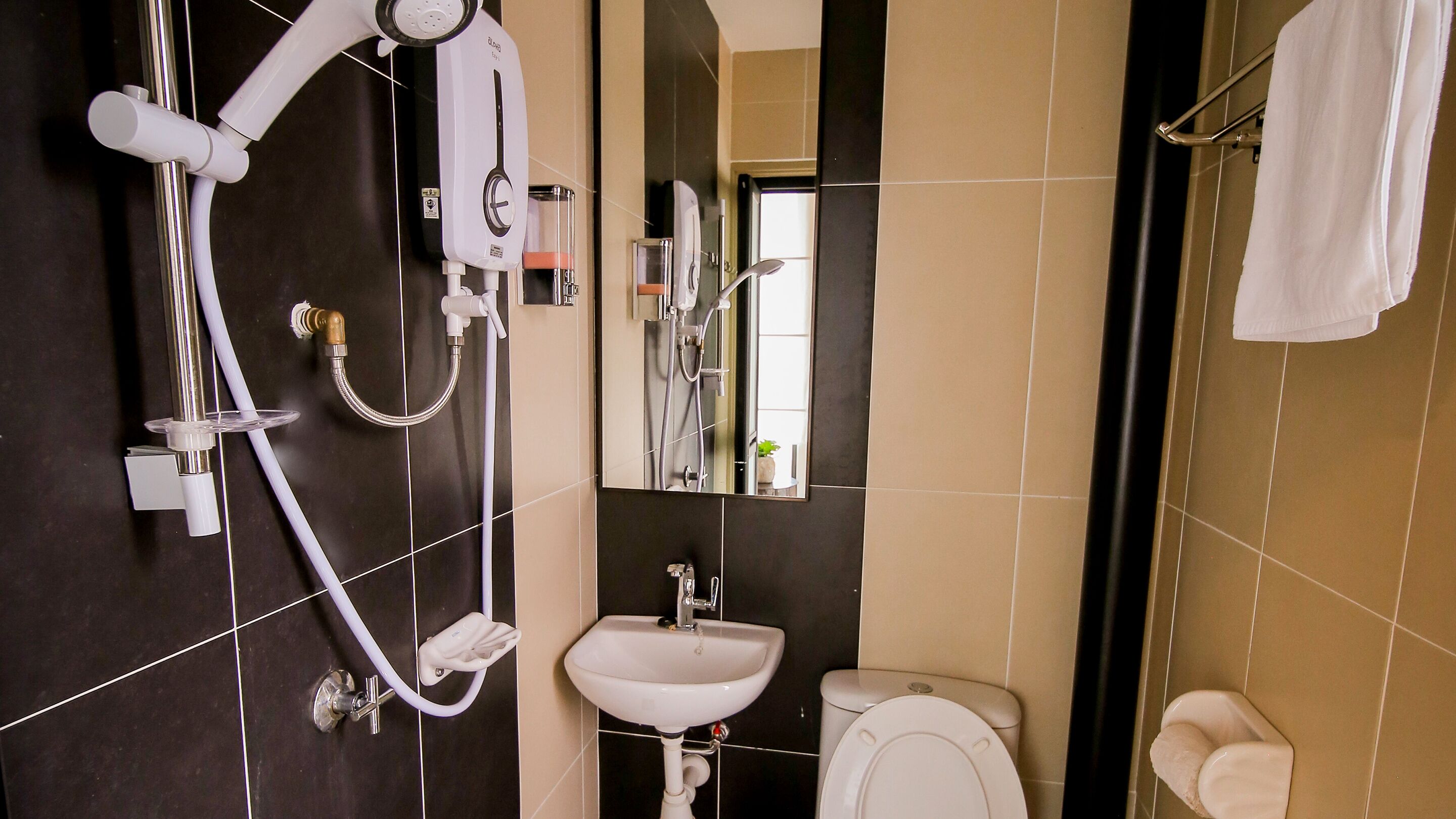 A modern bathroom with a shower, sink, and toilet.