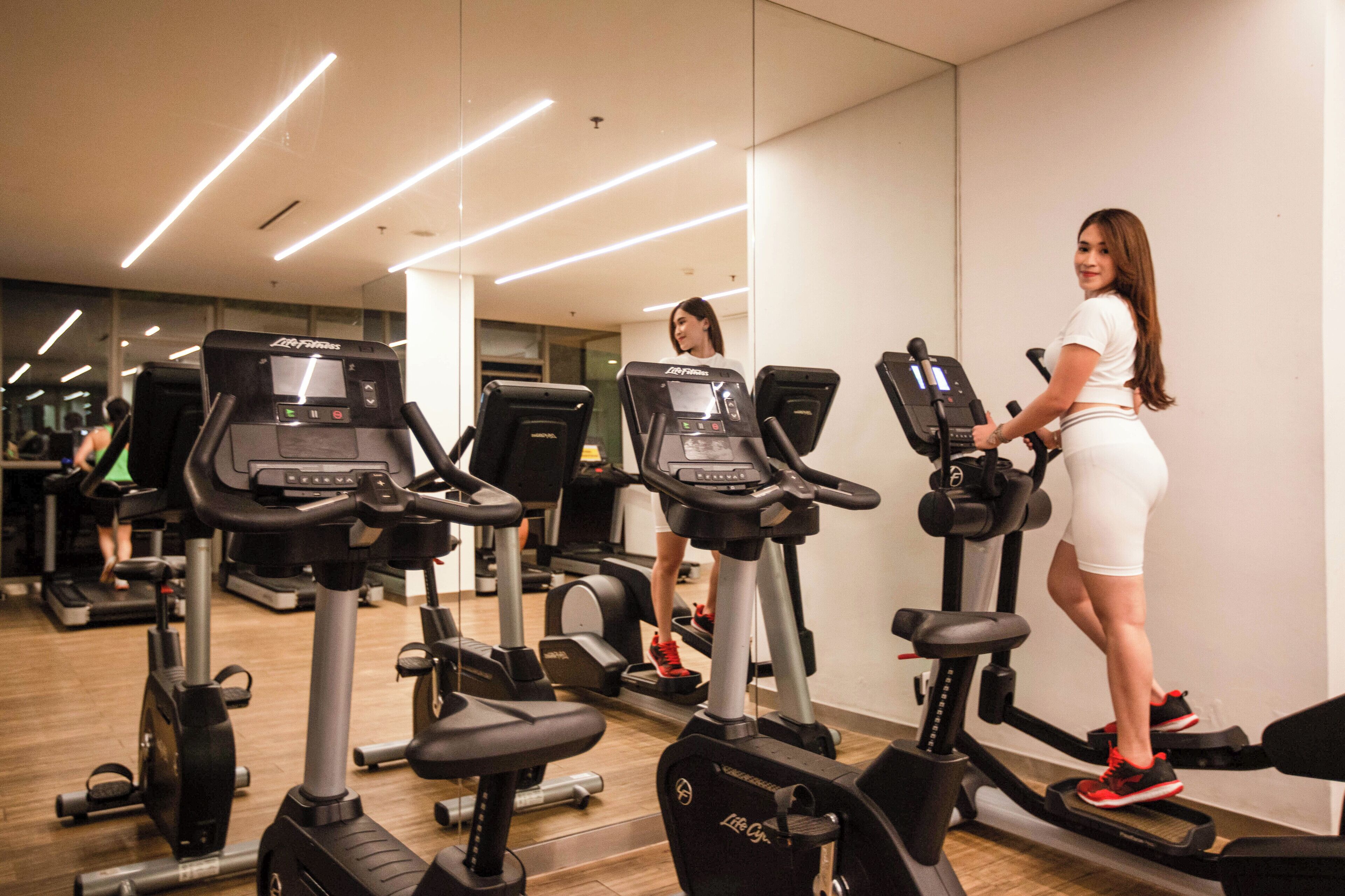 A gym with multiple treadmills and exercise equipment.