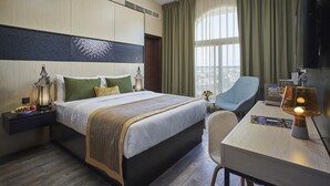 A hotel room with a large bed, bedside tables, a desk, and a chair. - Express By TIME - Al Khan (Sharjah)