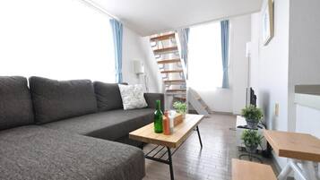 Quadruple Room | Living area | Flat-screen TV