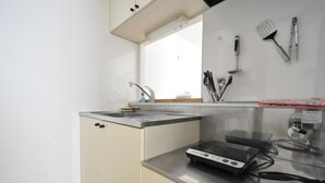 A kitchen with a sink, countertop, and various utensils. - IK Minami6Jo Residence 301 (Sapporo)