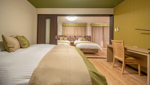 A hotel room with a large bed, a desk, and a chair. There are two beds in the background. - Residence Hotel Takayama Station (Takayama)