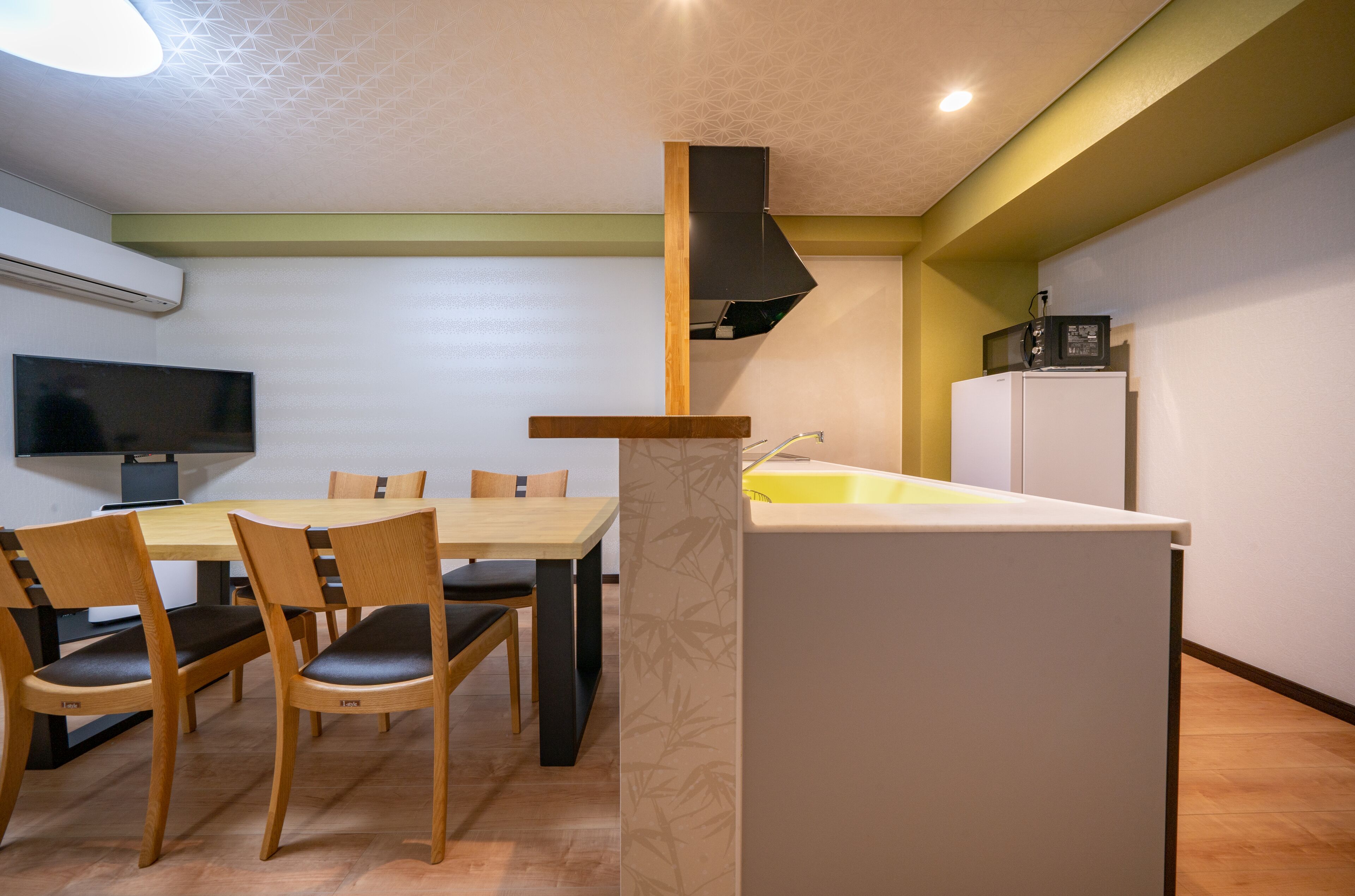 A compact kitchen with a dining area, a built-in stove, and a microwave.