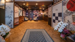 A reception area with a checkered floor, wooden panels, and a sign for Residence Hotel Takayama Station. - Residence Hotel Takayama Station (Takayama)