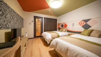 A hotel room with two beds, a desk, and a chair. There is a door leading to a bathroom and a wall with a geometric pattern.