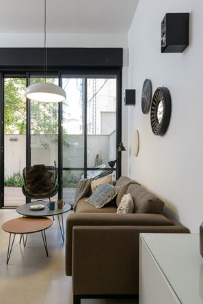Design Apartment | Living area | 60-inch LCD TV with cable channels, TV - Garden 1 Bedroom Apartment (Tel Aviv)
