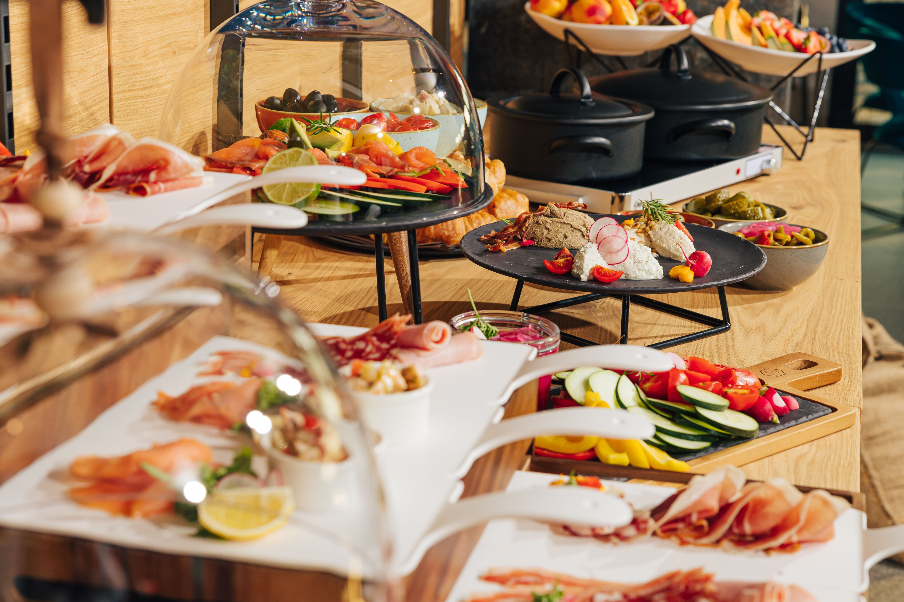 A buffet with various dishes including seafood, vegetables, and meats.