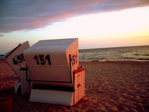On the beach, white sand, sun-loungers