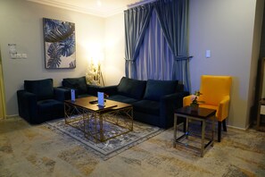 Family Apartment (One-Bedroom Apartment) | Living area | Flat-screen TV