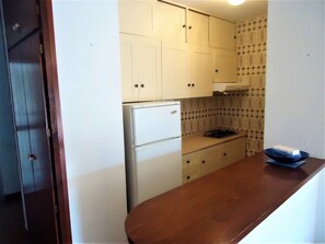 Fridge, microwave, coffee/tea maker, cookware/dishes/utensils