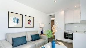 A modern living room with a sofa, a coffee table, and artwork on the wall. - Genteel Home Mateos Gago V (Seville)