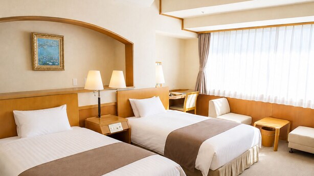 Une chambre d’hôtel avec deux lits, un bureau, une chaise et une fenêtre avec des rideaux.