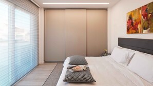 A modern hotel room with a large bed, a sliding door closet, and a large window with blinds. - Sunlight Acropolis Loft (Athens)