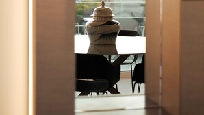 A modern interior with a view through a window, a hanging light fixture, and a marble sculpture. - Sunlight Acropolis Loft (Athens)