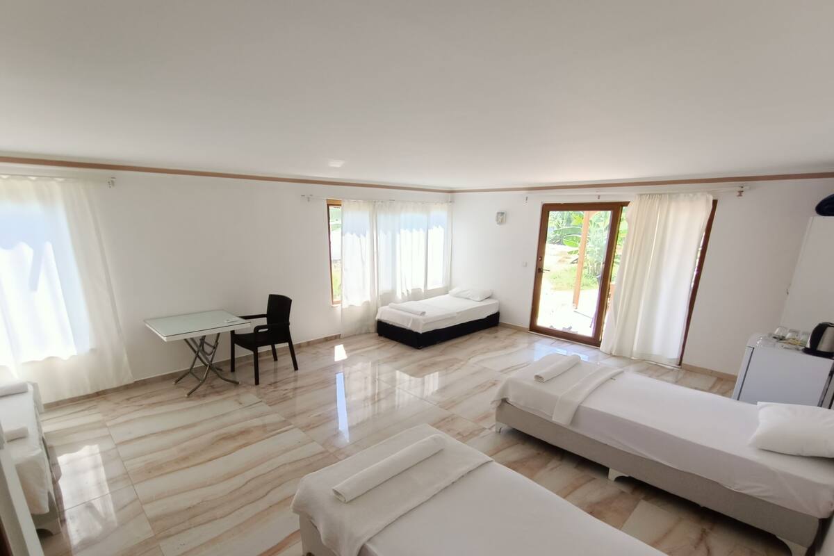 A room with a bed, a desk, and a chair.