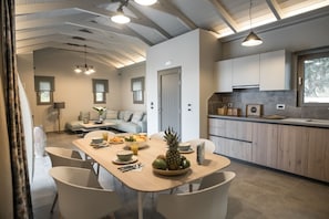 Enjoy meals in the dining area with a wooden table and comfortable seating.
