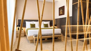 A room with a bed, bedside tables, a bench, and bamboo decor. - Atera Business Suites (Belgrade)