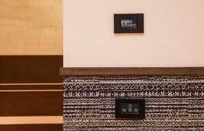 Control panels and digital clocks are conveniently located for easy room control.