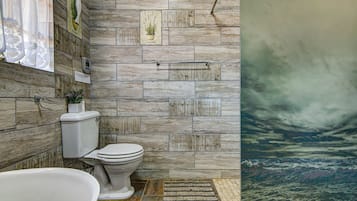 Bathtub, hair dryer, towels, shampoo
