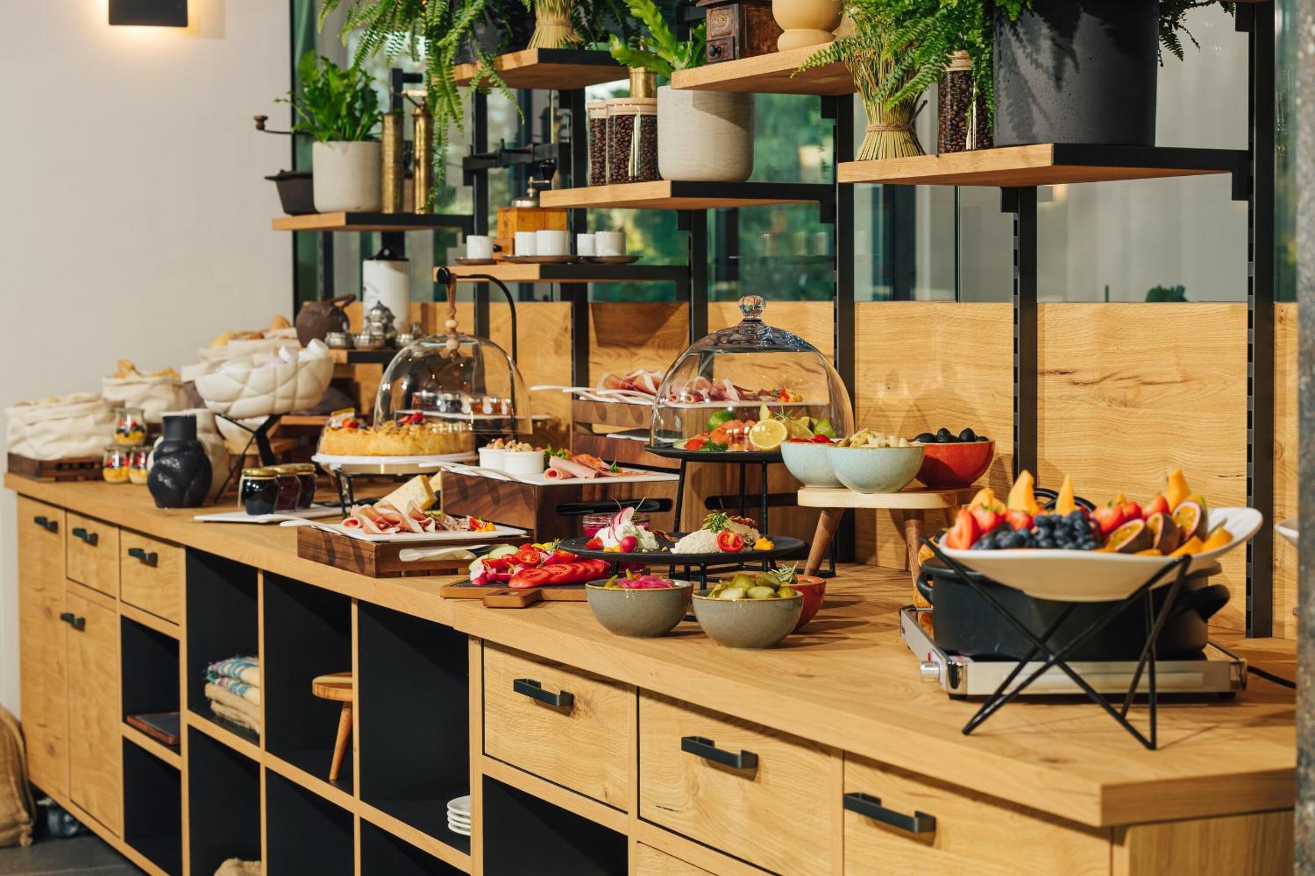 A buffet setup with various food items and a coffee station.