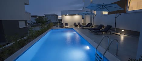 Seasonal outdoor pool, pool loungers