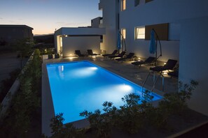 Seasonal outdoor pool, open 9:00 AM to 9:00 PM, pool loungers