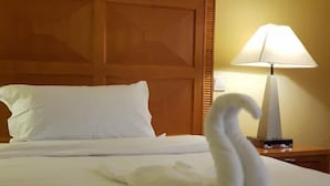 A neatly made bed with a swan-shaped towel in a hotel room. - Sodere Resort Hotels Africa Union (Addis Ababa)