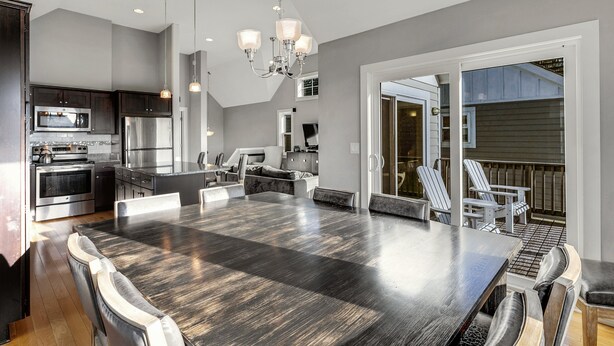A spacious kitchen with modern appliances, a large dining table, and a cozy seating area.