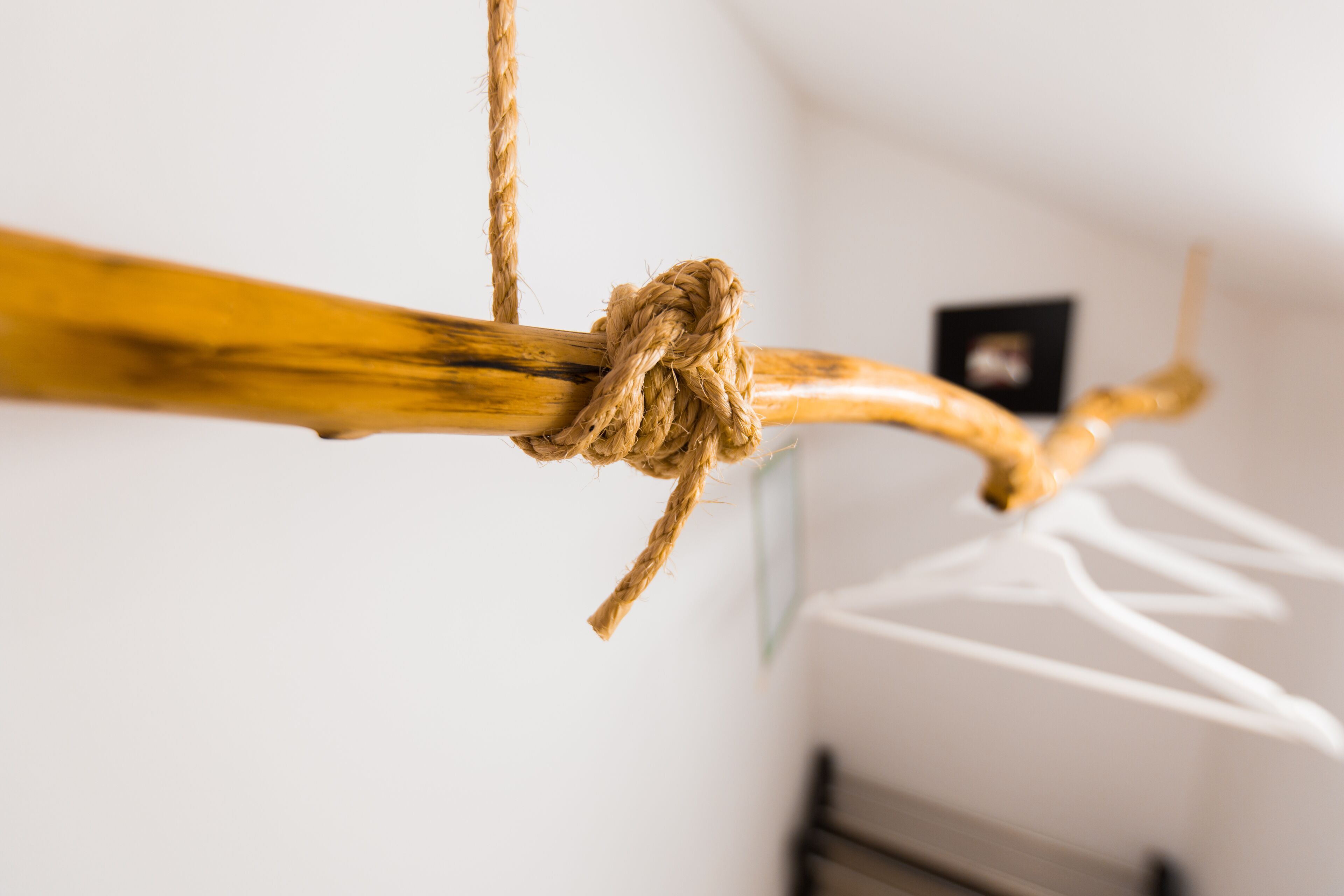 A wooden structure with ropes tied around it, likely part of a hanging system.