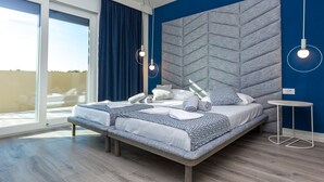 A modern bedroom with a bed, a bedside table, a large window, and a view of the outdoors. - Villa Sara (Novalja)