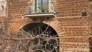 A two-story brick building with a balcony on the upper floor and a window on the lower floor. - Seiano (Vico Equense)