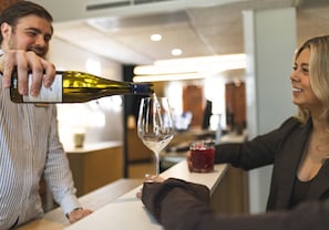 A person pouring wine into a glass.