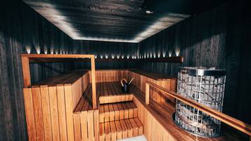 Sauna, jossa on puiset lauteet ja kivistä tehty allas.