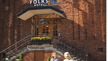A brick building with a sign reading 'The Folks Hotel.'