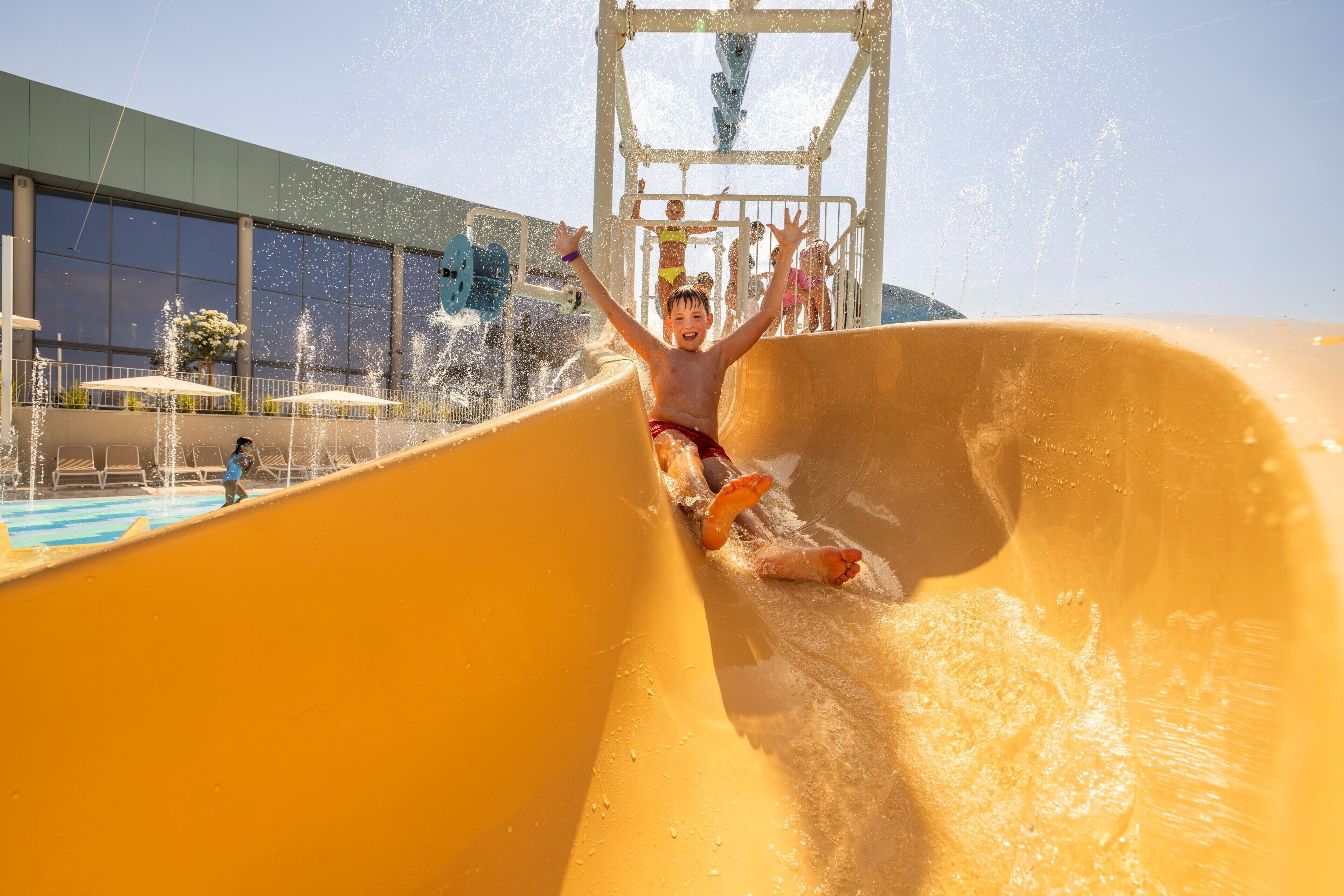 A person sliding down a water slide at a water park.