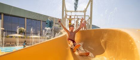A person sliding down a water slide at a water park.